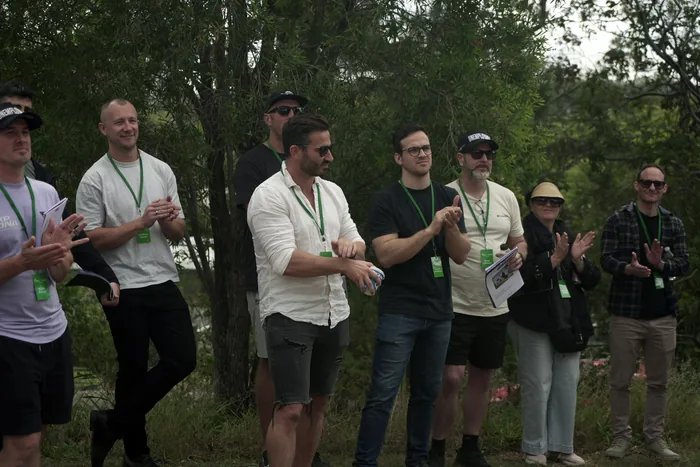 Members applauding during a site walkthrough on the bus tour
