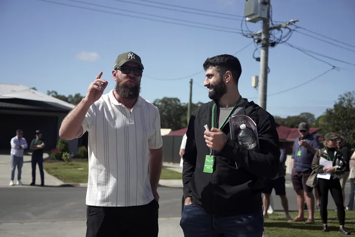 Two members walking a street of development sites