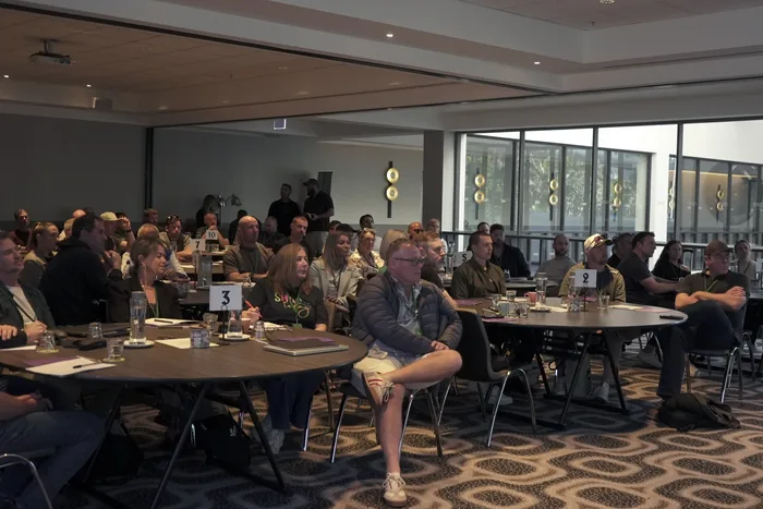 Members seated at round tables during a members only in-room day